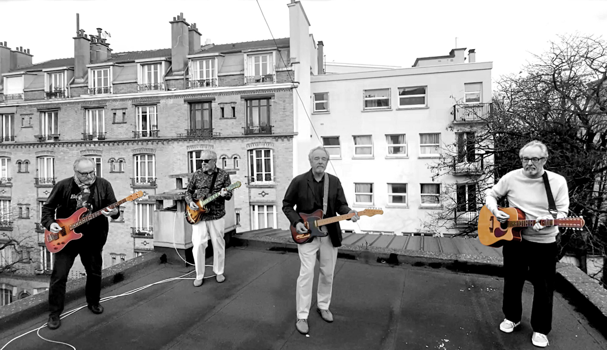 Four Brian Hancills on a rooftop in Paris